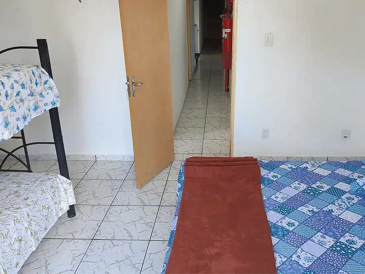 Quarto com beliche, cama de casal e tapete